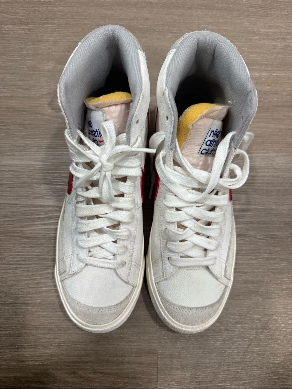 Nike White High-Top Sneakers with Red Swoosh and Yellow Tongue